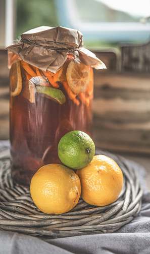 plant glass jar on gray surface beside lemons fruit